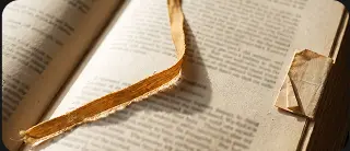 A gold ribbon marking a page in an open book